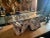 A 1960s mid century burl wood coffee table with original glass top — gray wood. Measures 51.5"W x 15.5"D x 18"H. Great...