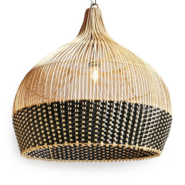 Hand woven pendant light crafted from natural wicker with a striking two-tone weave. The open vertical ribs taper...