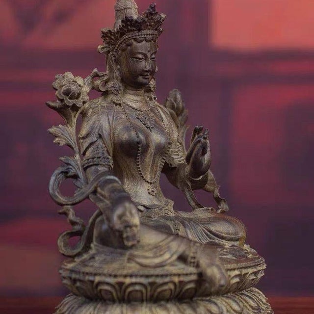 This vintage wood carving of a sitting Green Tara Buddha statue is a unique and spiritually significant piece that...