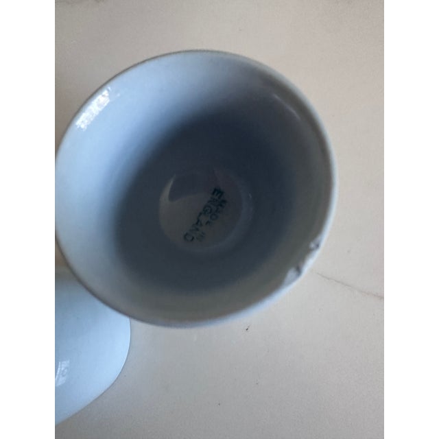 A charming pair of vintage ceramic egg cups made in England, finished in a soft robin’s egg blue glaze that feels equally...