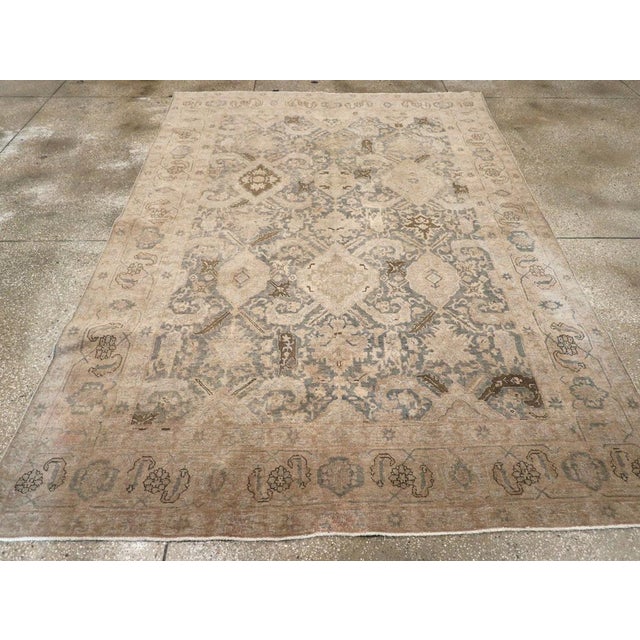 This early 20th-century Persian Afshar small room-size carpet presents a softly balanced tribal composition in muted...