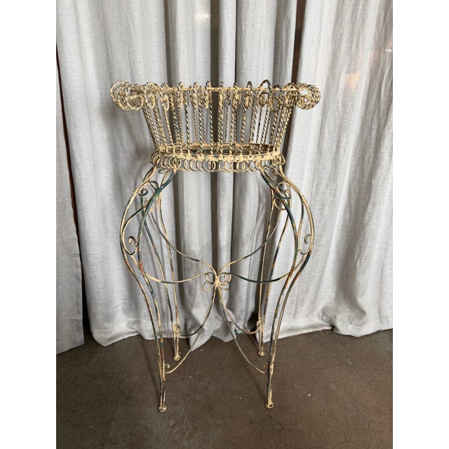 Beautiful vintage wrought iron, painted metal garden planter stand. It features a basket-style top, used for holding...