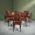 This set of six dining chairs features a solid teak frame with moulded plywood seats. The backs have a gentle wing shape,...