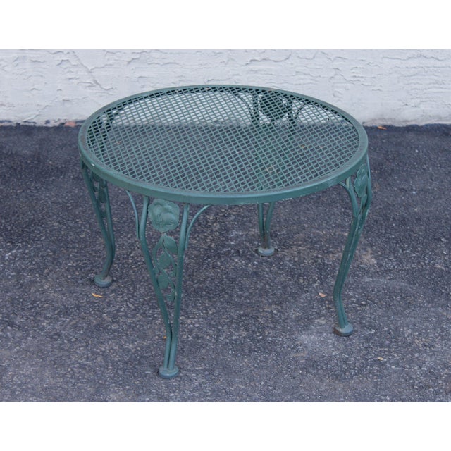 High Quality Wrought Iron Patio Table Featuring A Round Mesh Top Surface Supported By Decorative Legs With Cast Floral...