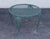 High Quality Wrought Iron Patio Table Featuring A Round Mesh Top Surface Supported By Decorative Legs With Cast Floral...