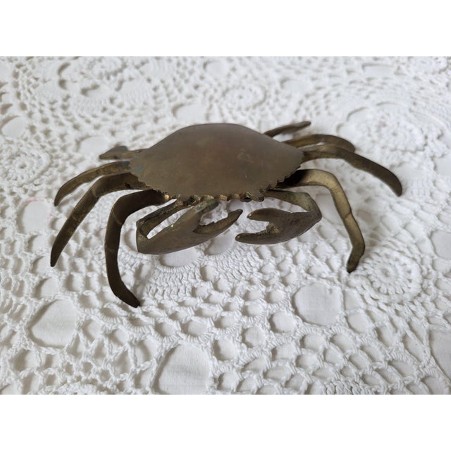 A coastal brass crab, likely from the 1950s or 1960s. There is age appropriate vintage wear, as shown. It measures 7” l x...