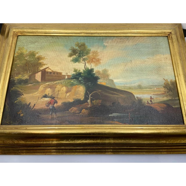 Mid century Venetian oil painting on canvas with a striking gold gift wood frame. Landscape depicted near a bed of water....