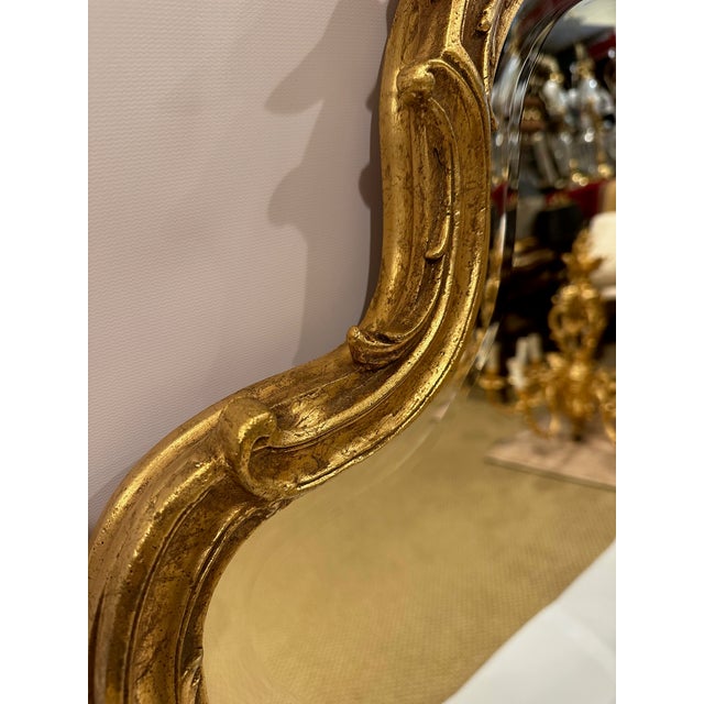 Large beautifully shaped Friedman Brothers French style wall mirror.