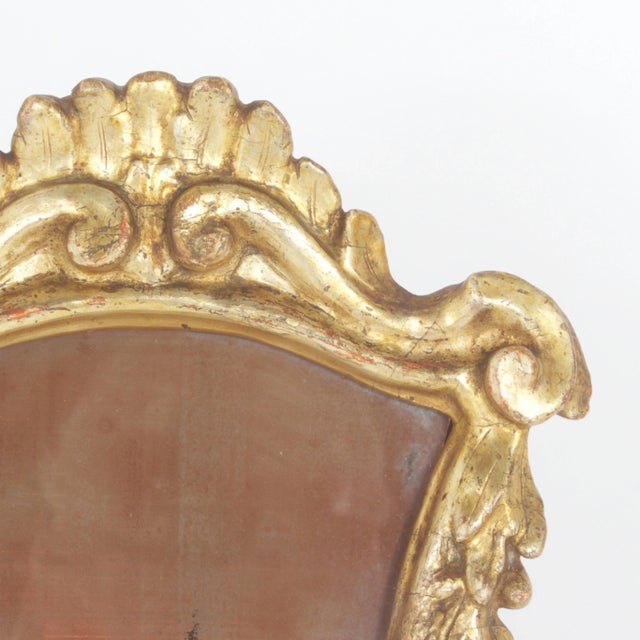 Charming Antique Italian carved and gilt frame presented on a wood easel, with a mirror so distressed, we are calling it a...
