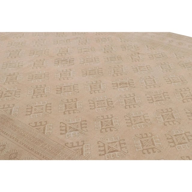 Hand-knotted in wool and originating from Turkey circa 1950-1960, this 9x13 vintage Ersari rug is from the same...
