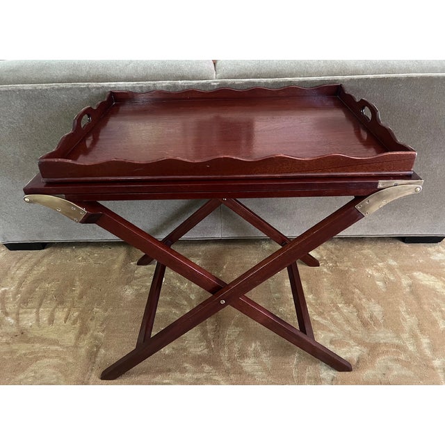 Mahogany tray table that unfolds to 89" in length. The table made by Baker Furniture in the 1950's is called the "Party...