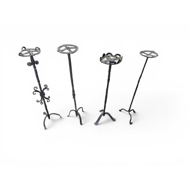 Rare and important set of four Spanish Gothic candlesticks, hand-forged in wrought iron during the late 15th century....