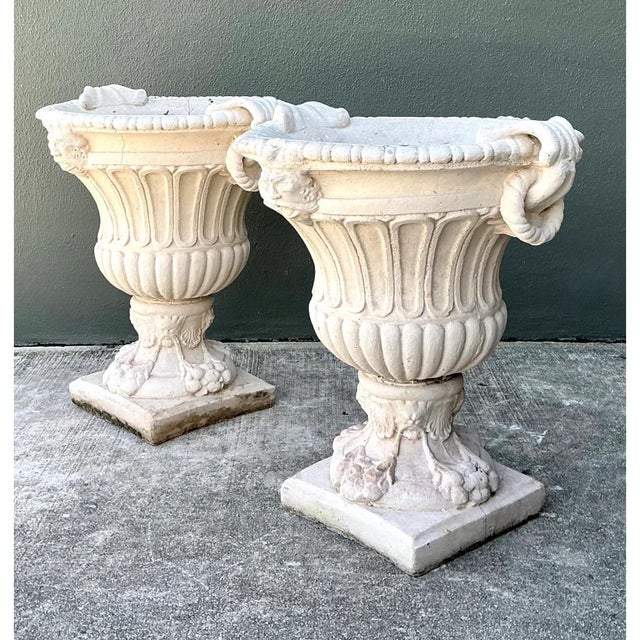 This pair of vintage cast stone garden urns presents a classical Campana silhouette, each with a deeply fluted bowl rising...