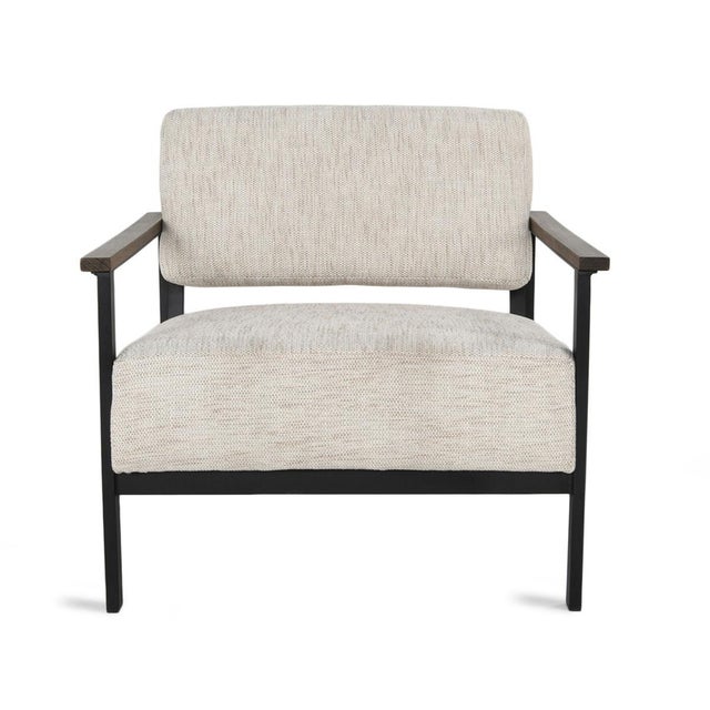This wide accent chair combines industrial character with natural warmth in a generously proportioned silhouette....