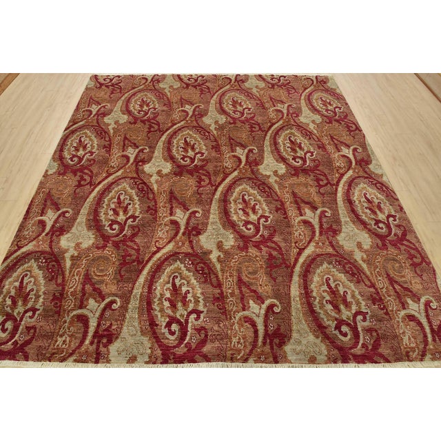 A modern traditional Suzani rug hand-knotted with fine wool on a cotton foundation. This rug features a botanical pattern...