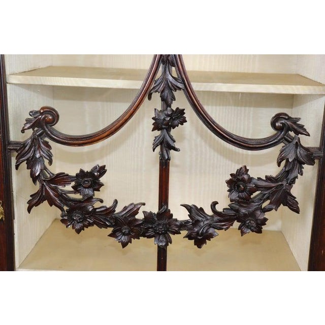 This magnificent English Georgian mahogany display cabinet embodies the grace, symmetry, and craftsmanship that define the...