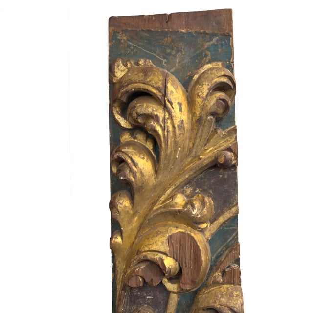 A tall, narrow carved wood architectural element with scrolling acanthus foliage and volutes worked in high relief. The...