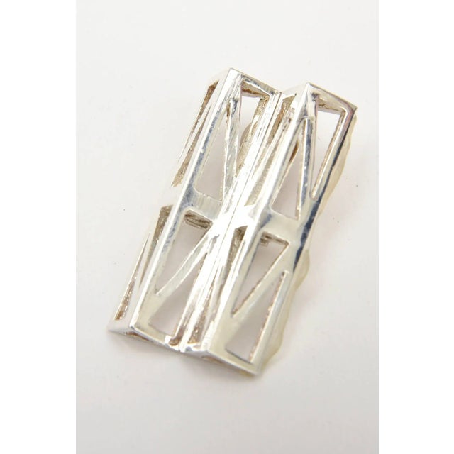 This is part of Chairish’s Costume Jewelry assortment. These oh so modernist geometric runway signed vintage silver-plate...