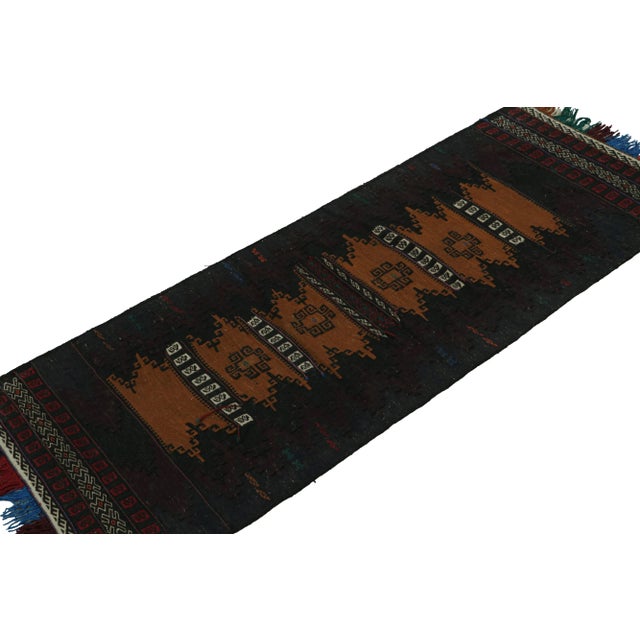 Handwoven in wool, originating from Afghanistan circa 1950-1960, its 2x5 size and design may signify origins as a table...