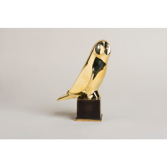 An Art Deco–style animal bronze of an owl, the bird pared down to a single smooth, rounded volume — broad head, large...