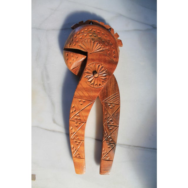 Vintage hand-carved wooden nutcracker, likely originating from Scandinavia or the Nordic region as a piece of folk art....