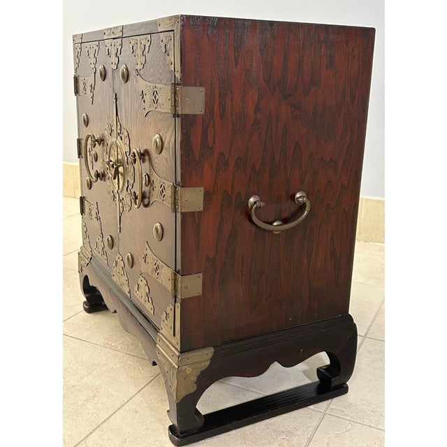 Attractive two door walnut chest with brass hardware and highlights. Two drawers and spacious storage inside. Unique,...