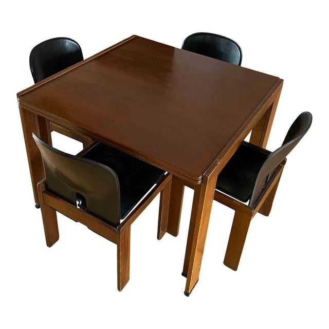 A dining set composed of four 121 dining chairs and a 778 dining table designed by Afra & Tobia Scarpa in 1965 and...