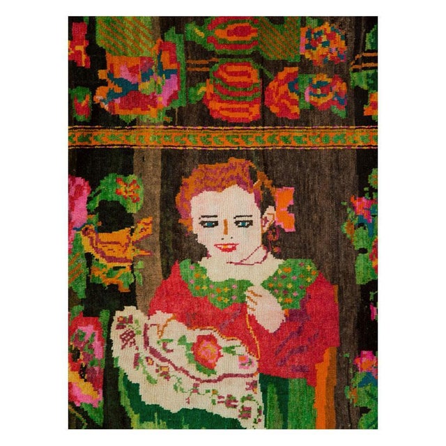 A vintage Caucasian Karabagh accent rug handmade during the mid-20th century with a pictorial design of 2 women sewing...