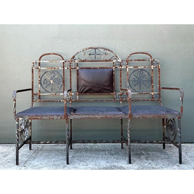 This vintage metal bench presents a compelling study in decorative wrought ironwork, its three-seat design unified by an...