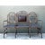 This vintage metal bench presents a compelling study in decorative wrought ironwork, its three-seat design unified by an...