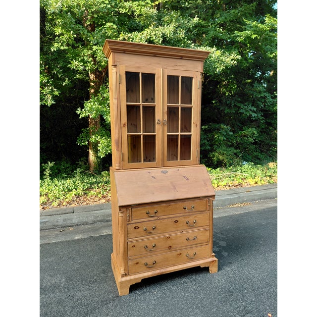 Handsome vintage secretary crafted in warm, richly grained pine. The upper bookcase features two mullioned glass doors...