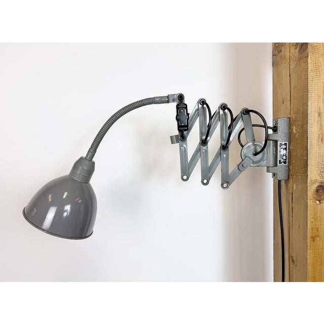 This vintage industrial adjustable gooseneck grey scissor wall light was produced by Elektroinstala Dečín in former...