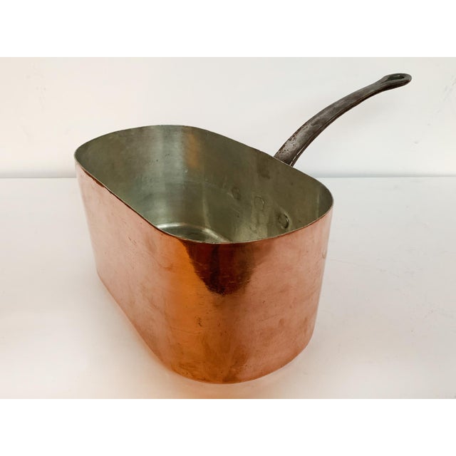 This vintage rectangular copper pot was crafted in France and is built to last. It has a lustrous exterior, an enameled...