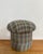 Charming mushroom-form pouf stool upholstered in a green, raspberry, blue, and cream plaid fabric that adds cozy texture...