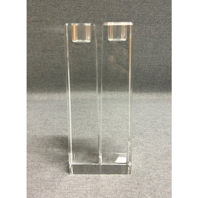 A pair of Oleg Cassini crystal candlesticks featuring a clean modernist design with a squared column and recessed candle...
