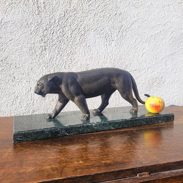 Large bronze panther with a brown patina, walking on a green marble base Good overall condition, some scratches and chips...