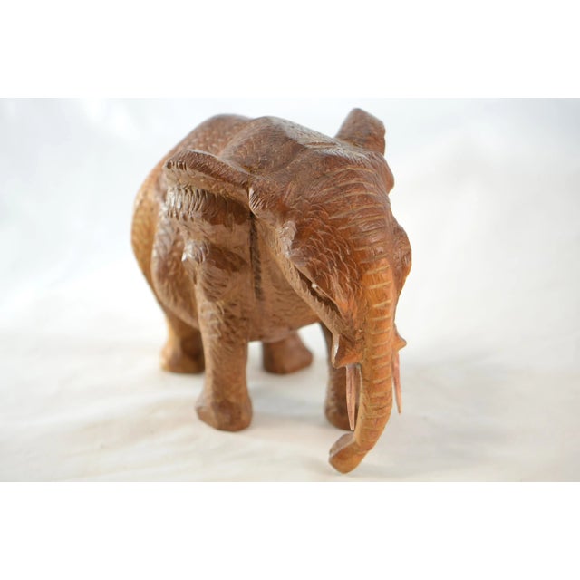 Artisan carved solid wood elephant with intricate cross hatching body texture. No maker's mark.