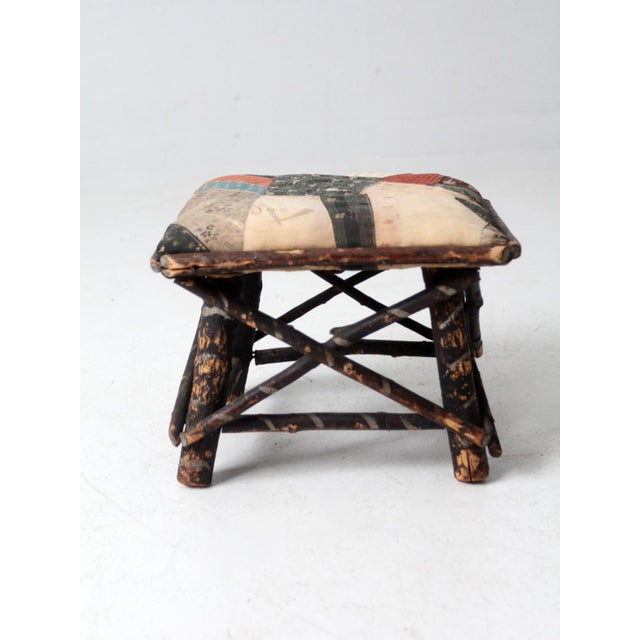 This is an antique Adirondack twig stool. The rustic little footstool features a willow frame with painted accents and a...