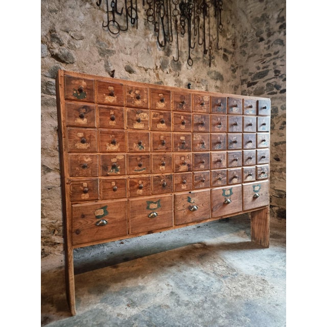 A large and characterful 19th century drawer cabinet, crafted from solid pine and featuring an exceptional arrangement of...