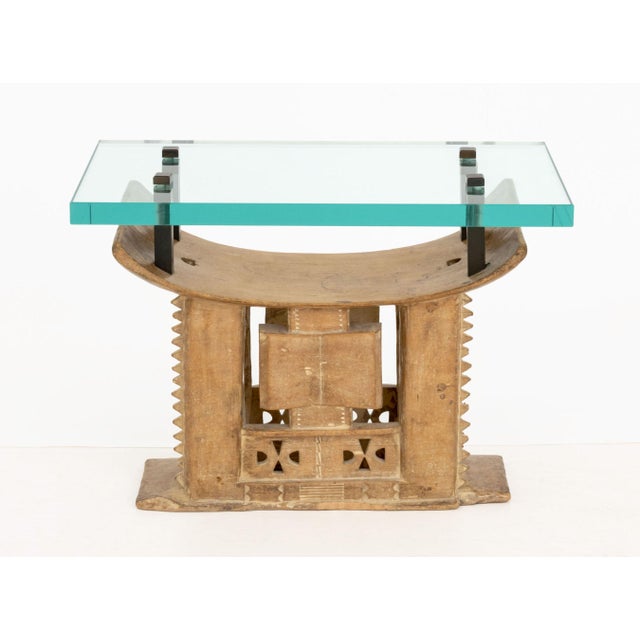 Karl Springer (German/American, 1931-1999) Ashanti Hand-Carved Wood Stool Base Side Table, 1970s, the glass top mounted...