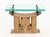 Karl Springer (German/American, 1931-1999) Ashanti Hand-Carved Wood Stool Base Side Table, 1970s, the glass top mounted...
