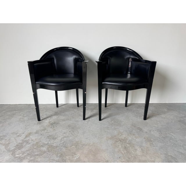 A striking pair of 1980’s Italian Art Deco–Postmodern club chairs, showcasing the bold sculptural silhouettes and glossy...