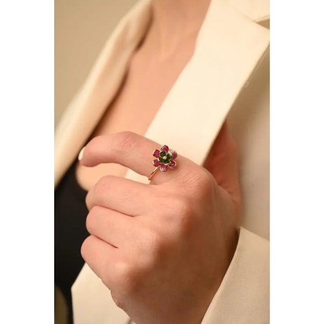 This is part of Chairish’s Fine Jewelry assortment. Emerald and Ruby Flower Open Ring in 18K gold with Diamond which...