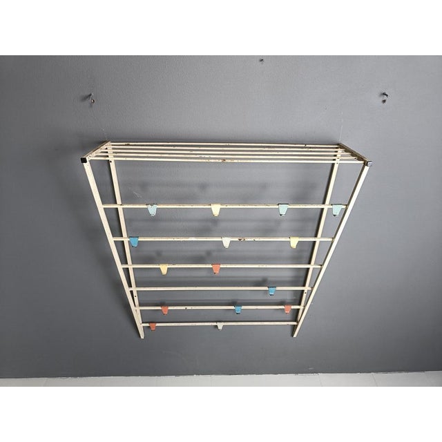 Mid century 'tone ladder' coat rack designed by Tjerk Reijenga for Pilastro. White metal frame with interchangeable hooks....