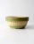 Antique yellowware bowl from the late 1800s featuring a classic ribbed design with green accents around the base and rim....