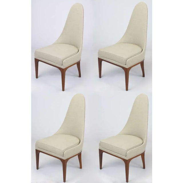 Set of four tall spoon back chairs with rosewood legs and apron. Restored in unbleached linen with new upholstery...