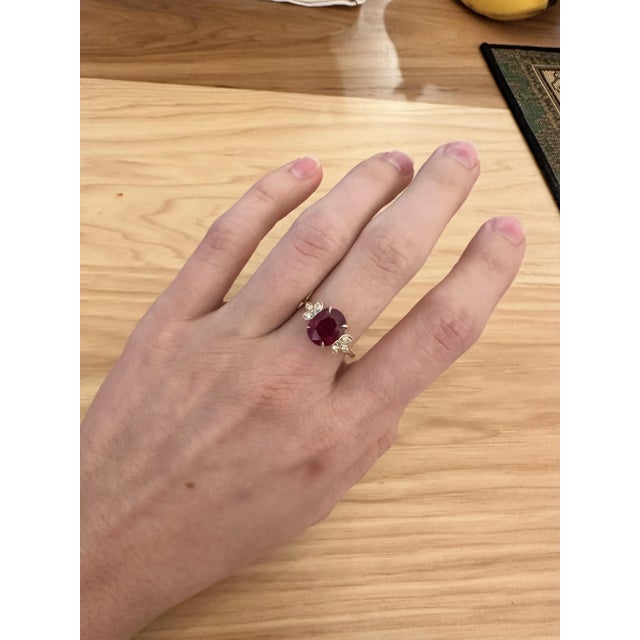 This beautiful ring features a 4.01 carat oval Ruby gemstone with natural earth mined diamonds set in solid 14K yellow...
