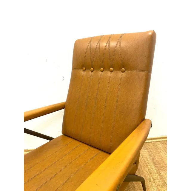 A retro adjustable armchair produced in Italy in the 1960s. The design combines sculptural metal legs and armrests with a...