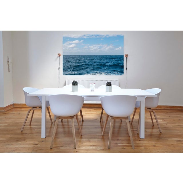 "Horizon Series". Each photo is divided into two halves, with the ocean in the upper half and the sky in the lower half....