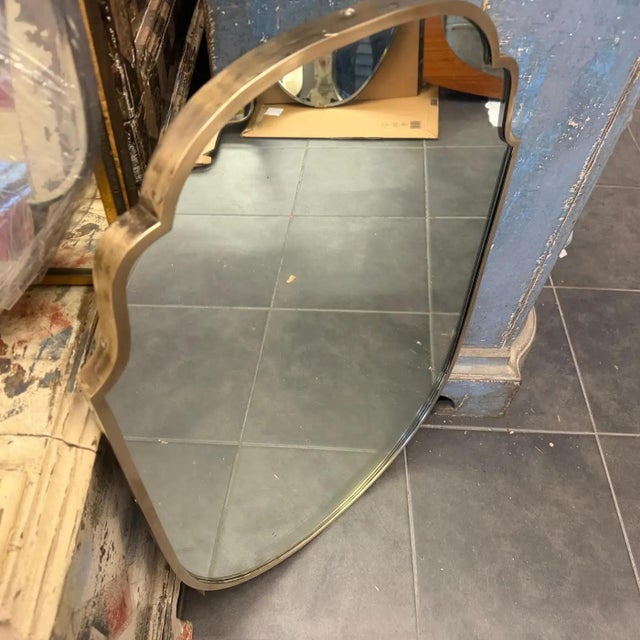 This mirror is a quintessential example of Mid-Century Modern Italian design, heavily inspired by the work of the...